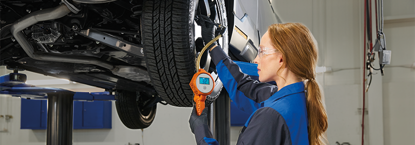 A Subaru technician checking tire pressure. | Wackerli Subaru in Idaho Falls ID