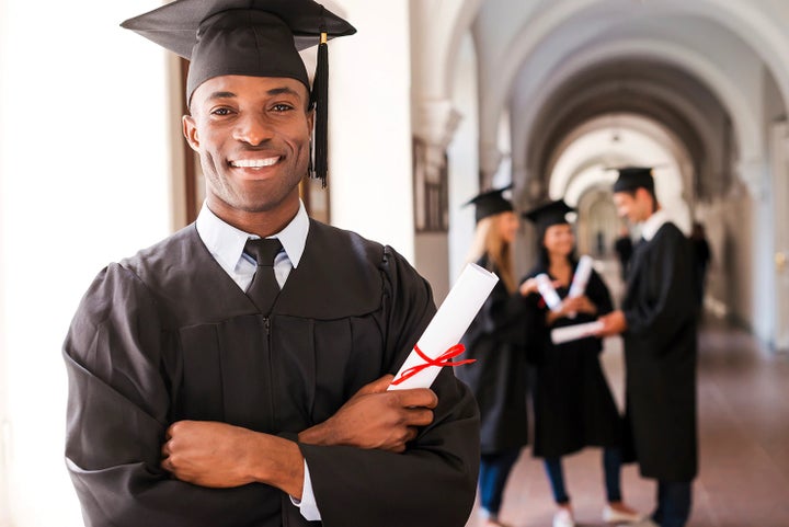 college graduate holding his diploma | Wackerli Subaru in Idaho Falls ID