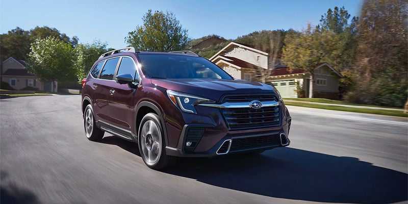 2023 Subaru Ascent driving through a neighborhood.