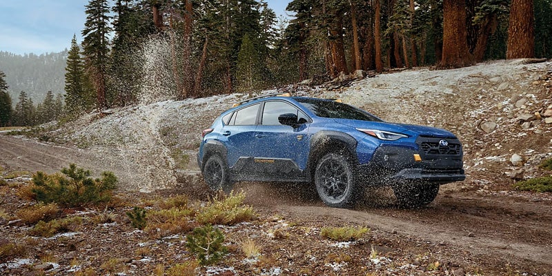 Blue Subaru Crosstrek driving off road